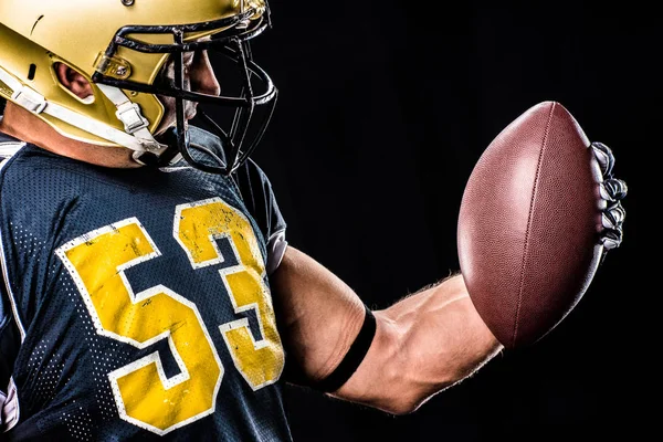 Muscular football player looking at ball — Stock Photo, Image