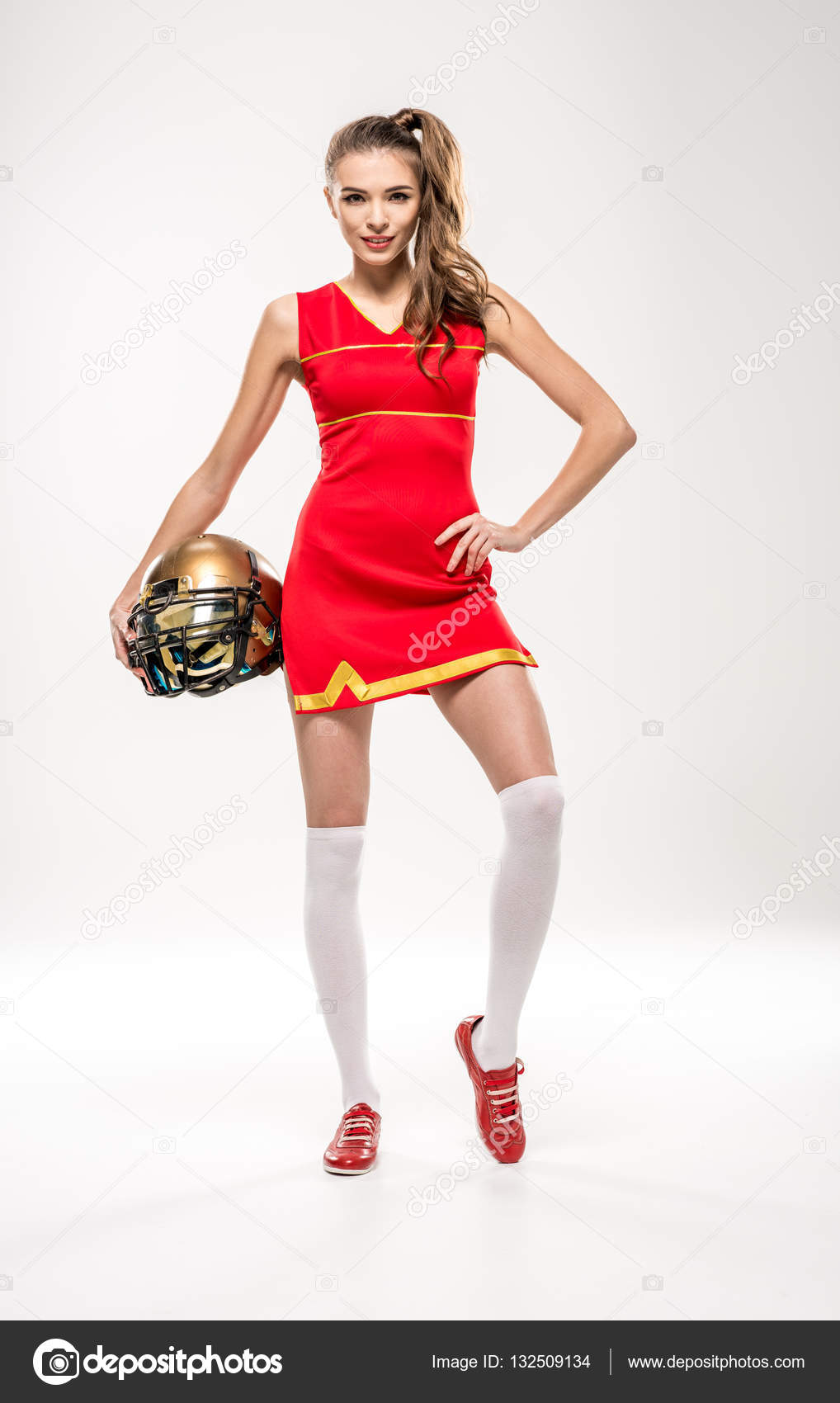 Cheerleader posing with helmet Stock Photo by ©DmitryPoch 132509134