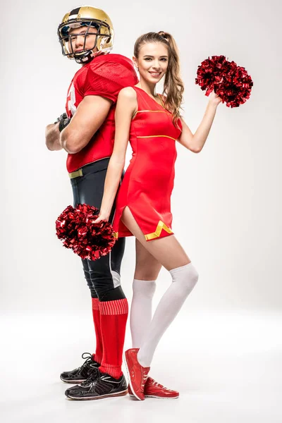 Football player standing with cheerleader — Stock Photo, Image