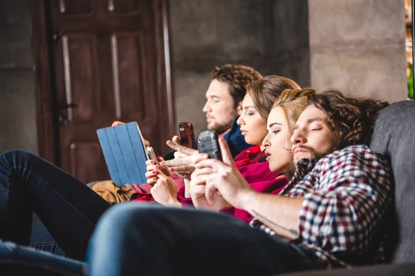 Serious friends using digital devices — Stock Photo, Image