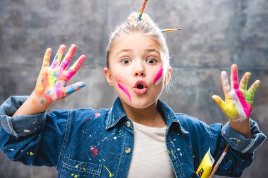 Schoolgirl artist with painted face clipart