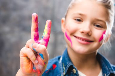 Schoolgirl artist with painted face clipart