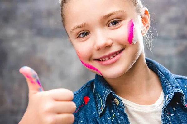 Schoolgirl artist with painted face — Stock Photo, Image