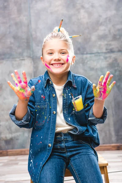Schoolgirl artist with painted face — Stock Photo, Image