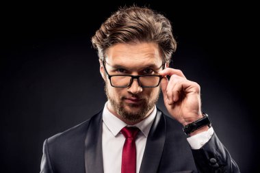 Businessman adjusting eyeglasses clipart