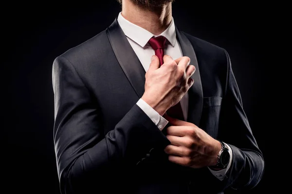 Businessman adjusting tie — Stock Photo, Image