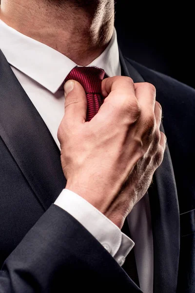 Businessman adjusting tie — Stock Photo, Image