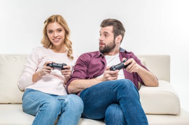 Smiling couple playing with joysticks   clipart