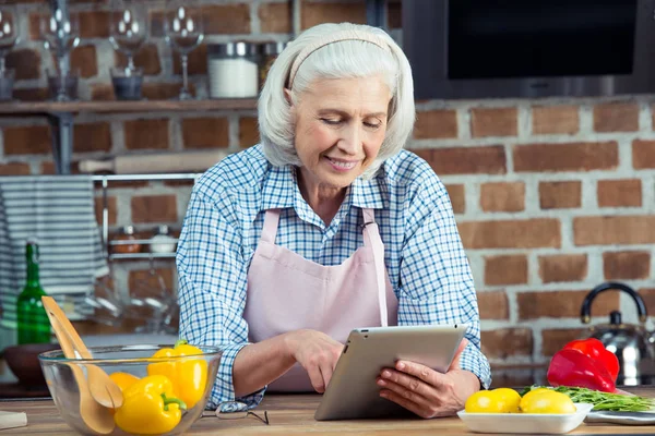 Mujer usando tableta digital en la cocina —  Fotos de Stock