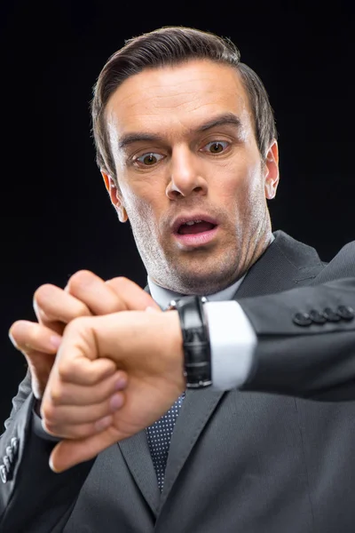 Scared businessman with wristwatch — Stock Photo, Image