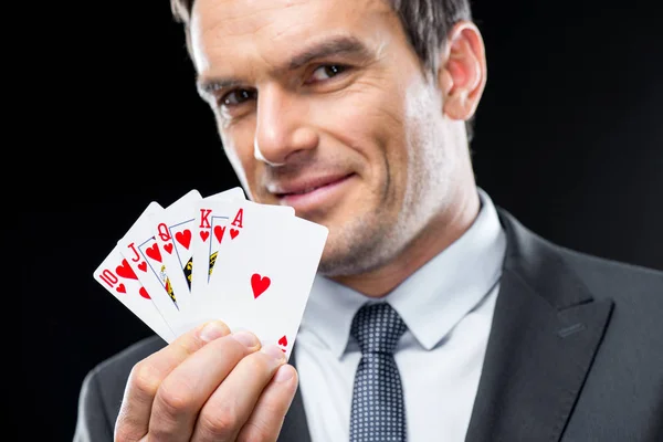 Homem segurando cartas de jogo — Fotografia de Stock