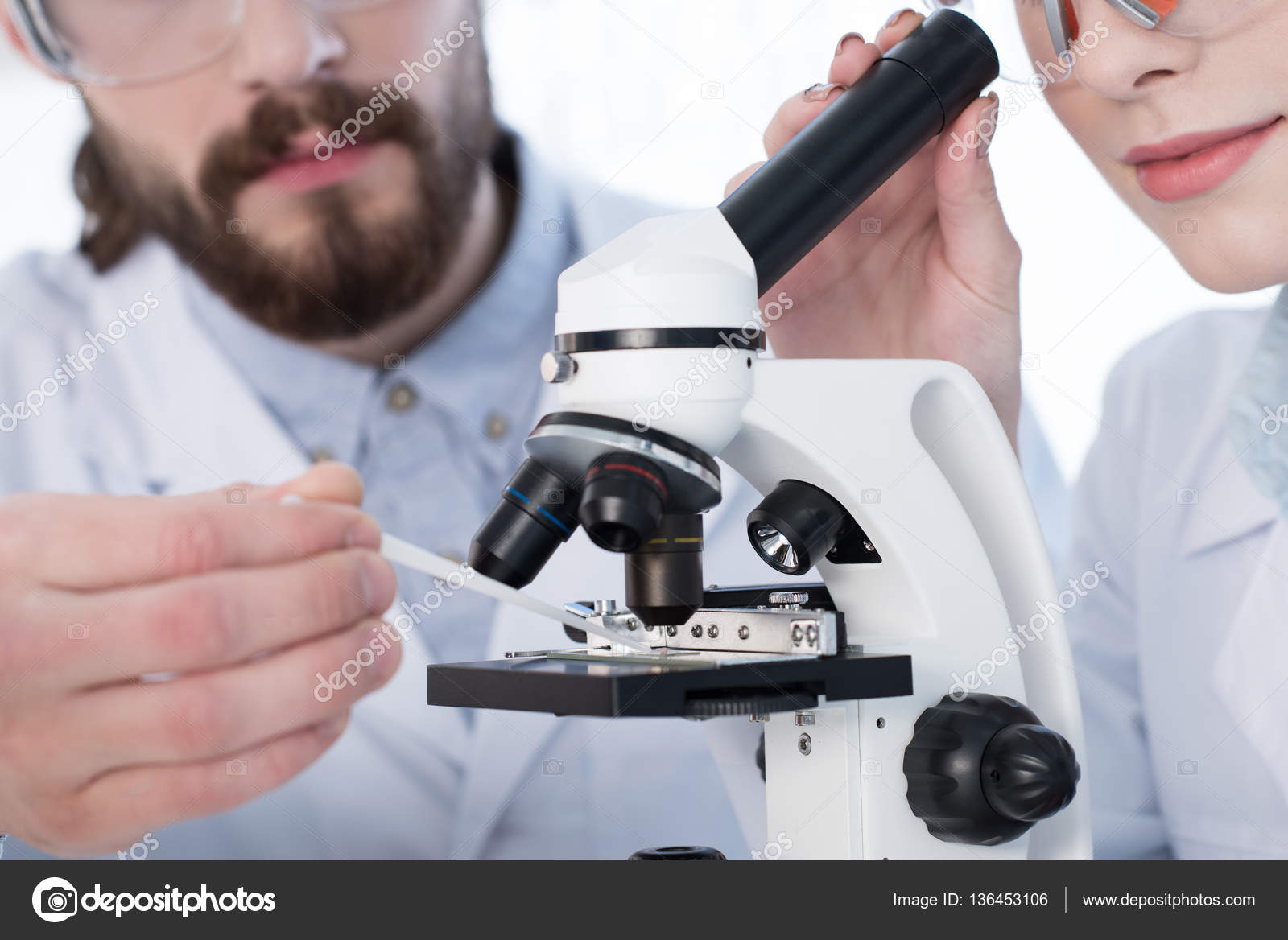 Chemists working with microscope — Stock Photo © DmitryPoch 136453106
