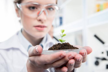 Female scientist with green plant clipart