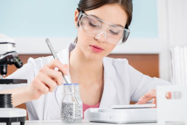 Female scientist in protective glasses  clipart
