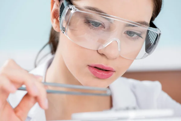 Female scientist in protective glasses — Stock Photo, Image