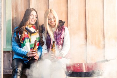 women holding beer bottles clipart