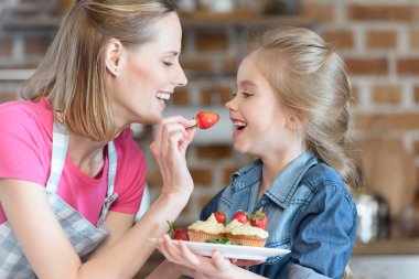 mother and daughter with pastry clipart