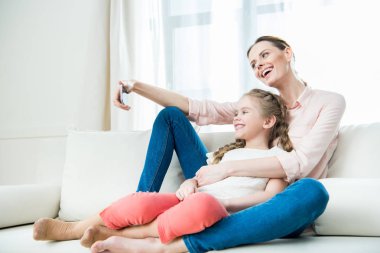 mother and daughter making selfie clipart