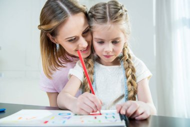 Mother and daughter drawing  clipart