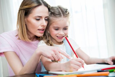Mother and daughter drawing  clipart