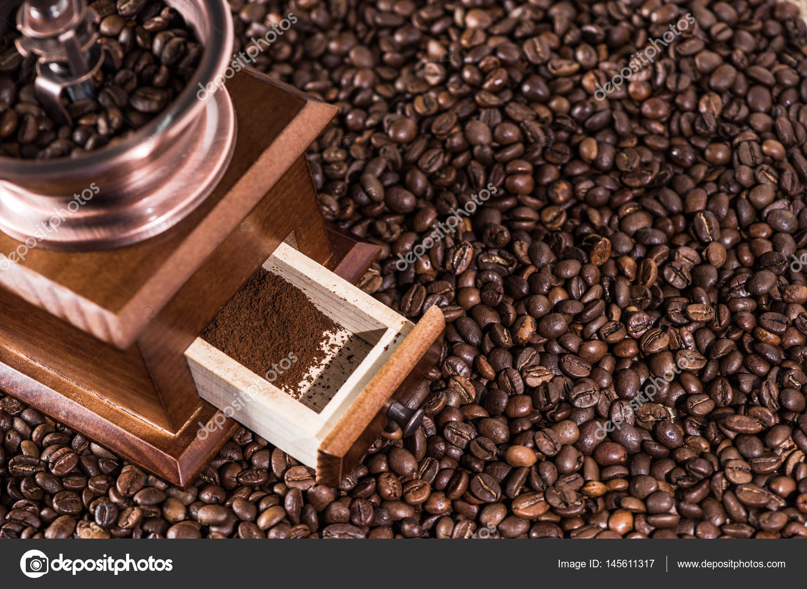 Coffee mill on coffee beans — Stock Photo © DmitryPoch 145611317