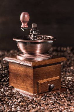 Coffee mill on coffee beans clipart