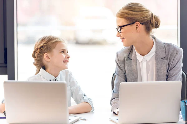 Mother and daughter with laptops — Stock Photo, Image