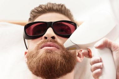 man receiving laser skin care clipart