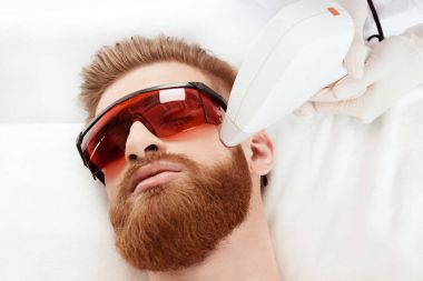 man receiving laser skin care clipart