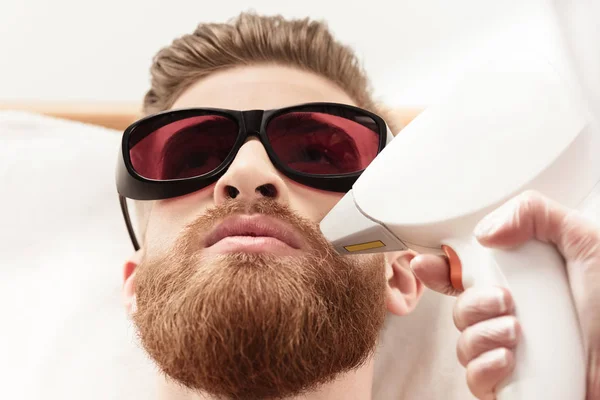 Man receiving laser skin care — Stock Photo, Image