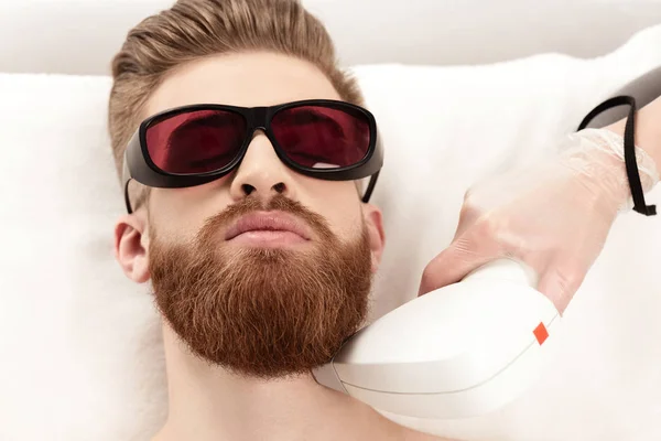 Man receiving laser skin care — Stock Photo, Image