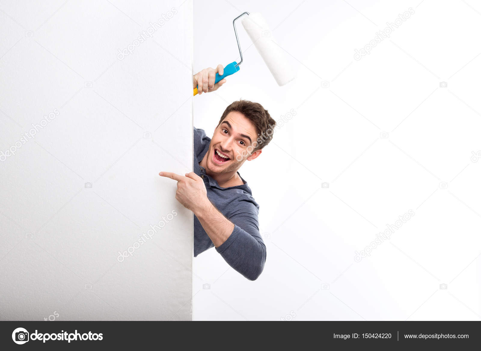 Man holding paint roller Stock Photo by ©DmitryPoch 150424220