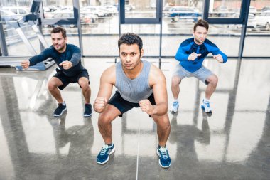 men exercising at sports center clipart