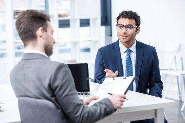 Businessmen at job interview  clipart