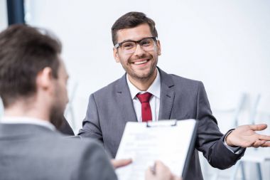 Businessmen at job interview  clipart