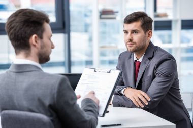 Businessmen at job interview  clipart