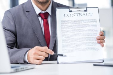 Businessman holding contract  clipart