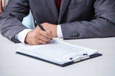 Businessman signing contract  clipart