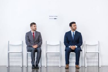 businessmen sitting on chairs clipart