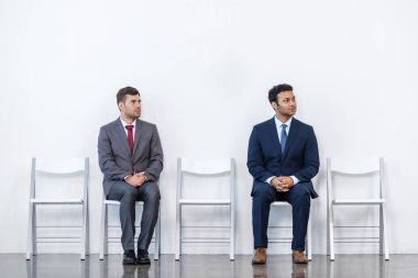 businessmen sitting on chairs clipart