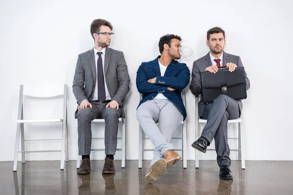 Businessmen sitting on chairs — Stock Photo, Image