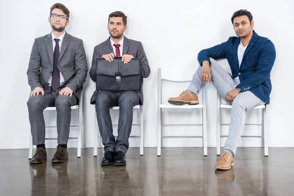 Businessmen sitting on chairs — Stock Photo, Image