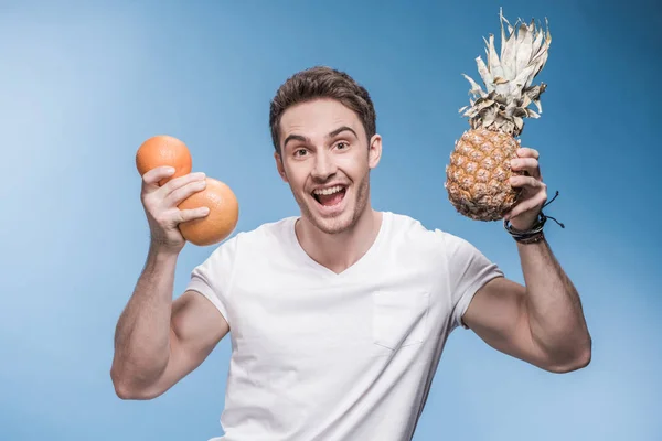 Young man with fruits — Stock Photo, Image