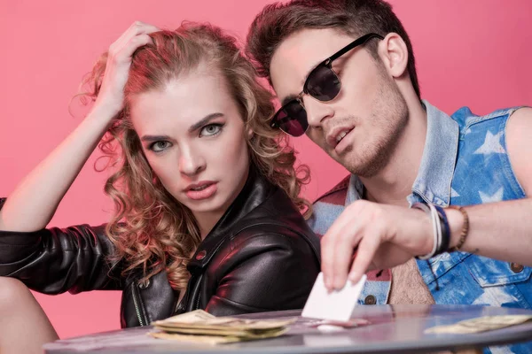 Couple with money on table — Stock Photo, Image