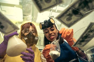 women preparing drugs in laboratory clipart