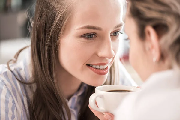 Young sensual girlfriends drinking coffee — Free Stock Photo