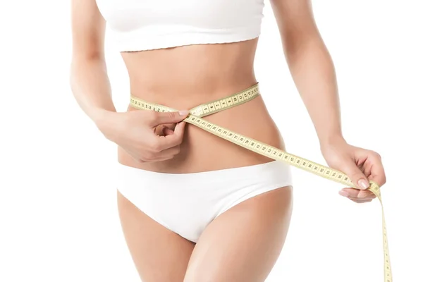 Woman measuring her waistline — Stock Photo, Image