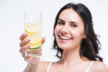 woman holding glass of water with lemon clipart