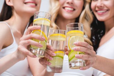 women clinking with glasses of water with lemon clipart
