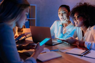 multiethnic businesswomen working with digital devices clipart